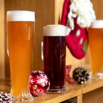 White and dark beer drink glasses, mugs with christmas, new year toys, decorations, gifts