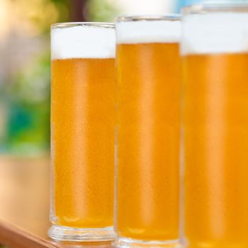 Beer mugs, glasses side by side close up