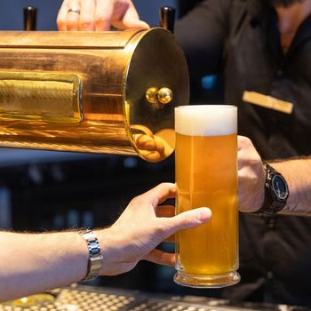 Man taking beer mug from bar