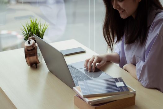 Online education. Asian girl online lesson using a computer video call to a virtual teacher at home.