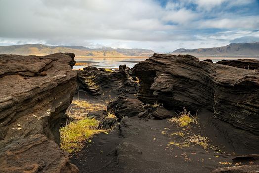 Volcanic rock formation near Dyrholaey in a cloudy day, Iceland