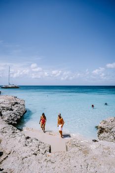 Tres Trapi Steps Triple Steps Beach, Aruba completely empty, Popular beach among locals and tourists, crystal clear ocean Aruba. Caribbean, couple man and woman in a crystal clear ocean 