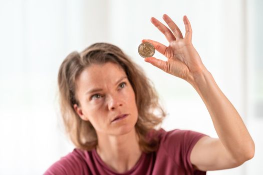 bitcoin coin in the hand of a young attractive business woman.