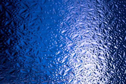 Abstract background of corrugated blue glass.Glass background.