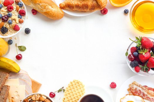 Healthy breakfast with muesli, fruits, berries, nuts, coffee, eggs, honey, oat grains and other on white background. Flat lay, top view, copy space for text, frame