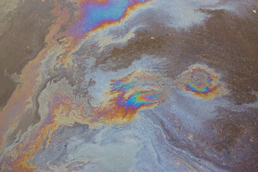 Oil stain on asphalt as texture or background.Environmental pollution concept.
