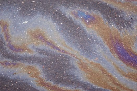 Beautiful abstract colorful background, texture, stains from engine oil on the asphalt.Colorful gas stain on wet asphalt