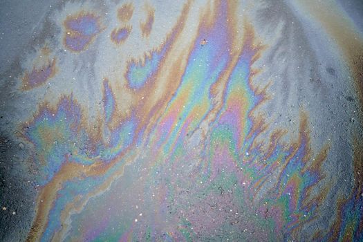 Beautiful abstract colorful background, texture, stains from engine oil on the asphalt.Colorful gas stain on wet asphalt