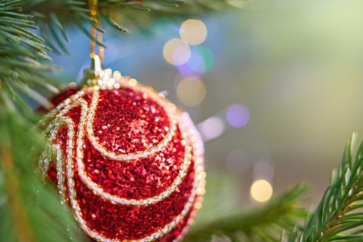 Cropped image of christmas tree with red toy in room. Soft selective focus. Close-up