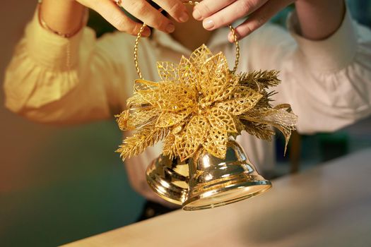 Childrens hands holding christmas toy bells.Close-up
