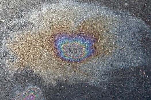 Beautiful abstract colorful background, texture, stains from engine oil on the asphalt.Colorful gas stain on wet asphalt