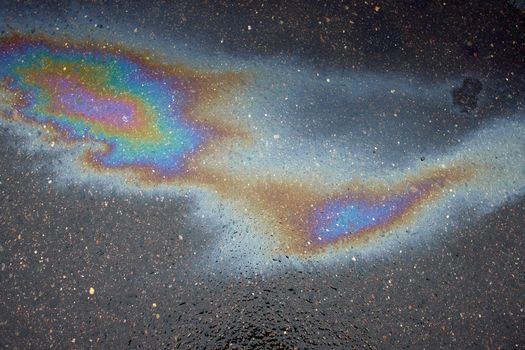 Beautiful abstract colorful background, texture, stains from engine oil on the asphalt.Colorful gas stain on wet asphalt.