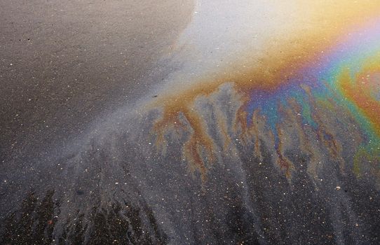 Beautiful abstract colorful background, texture, stains from engine oil on the asphalt.Colorful gas stain on wet asphalt.