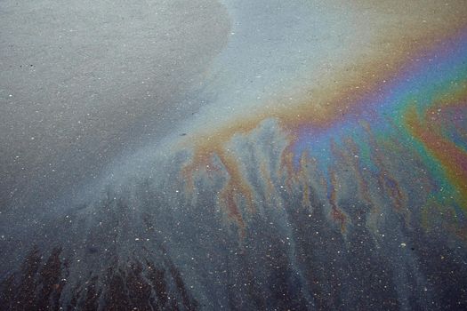 Beautiful abstract colorful background, texture, stains from engine oil on the asphalt.Colorful gas stain on wet asphalt.
