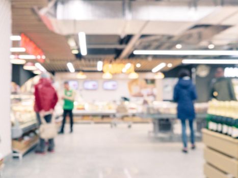 Blurred colorful supermarket products on shelves - background with shallow DOF