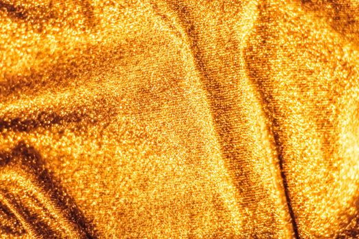 Luxe glowing texture, night club branding and New Years party concept - Golden holiday sparkling glitter abstract background, luxury shiny fabric material for glamour design and festive invitation