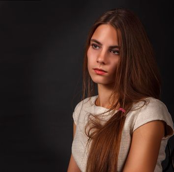 portrait of a young beautiful girl in studio on a black background