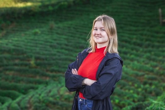 Maiden in a red blouse posing at the tea plantation in Haremtepe Ceceva village, Rize, Turkey.