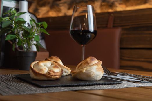 Homemade empanadas with a black stone plate.