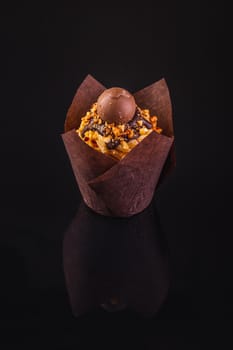 Peanut Butter Cupcake On A Black Background With Reflection.