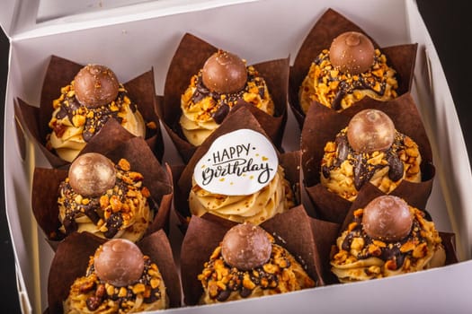 Box of Peanut Butter Cupcakes On A Black Background With Reflection.