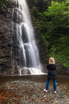 Woman posing at the Tar waterfall near Rize, Turkey.
