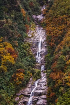 Ayder Plateau Natural Gelintulu Waterfall surrounded by autumn colors near Rize, Turkey.