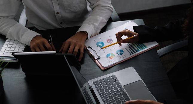 Two business teamwork calculating a valuation in workplace