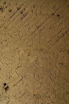 Cracked dry clay wall texture or background