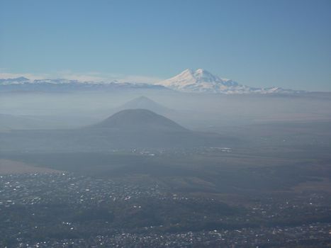 Mountain landscape, Nature of the North Caucasus. Mount Elbrus, a snowy peak against a blue sky. High quality photo