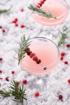 Goblet with cranberry Margarita with candied cranberries, rosemary. Perfect cocktail for a Christmas party