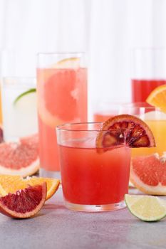 Refreshing freshly squeezed Sicilian orange juice among fresh detox citrus juices from  orange, grapefruit, lime