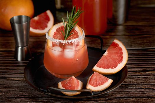 Cocktail tequila fresh grapefruit juice combined and rosemary. A festive drink is ideal for brunch, parties and holidays.