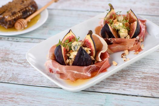 Figs stuffed with blue cheese, wrapped in Parma ham, drizzled with honey