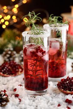 Glass with pomegranate Margarita with candied cranberries, rosemary. Perfect cocktail for a Christmas party