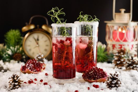 Glass with pomegranate Margarita with candied cranberries, rosemary. Perfect cocktail for a Christmas party