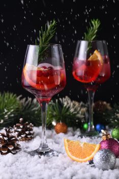 Cocktail Margarita with cranberries, orange and rosemary. A perfect cocktail for a Christmas party