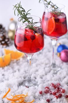 Cocktail Margarita with cranberries, orange and rosemary. A perfect cocktail for a Christmas party