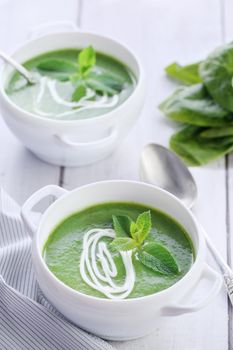 Spinach puree soup seasoned with cream and mint

