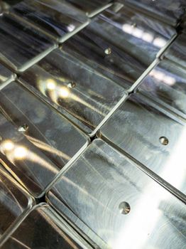 full frame background of shiny metal tiles after cnc surface milling - close-up with selective focus