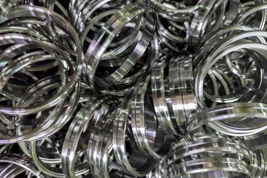 pile of shiny steel rings after cnc turning operations.