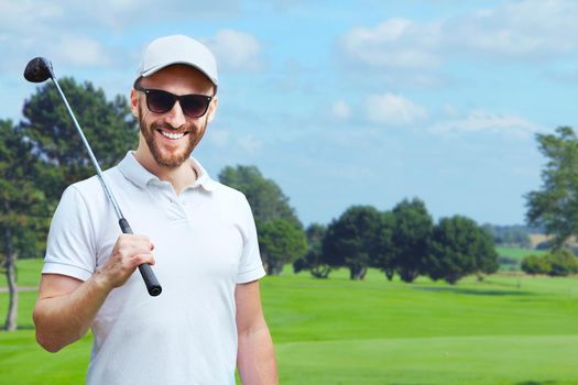 Portrait of male golfer with golf club at course