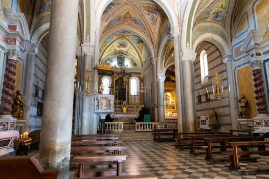 Corniglia, Liguria, Italy. June 2020. The interior of the church of San Pietro. From the windows the rays of the sun enter to illuminate the central nave.