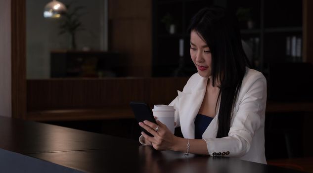 Business woman using smart phone for video call.