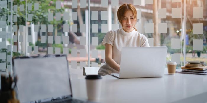 Asian Business woman checking email at morning in office. finance, fund, investment concept