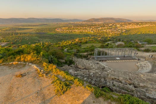 Tzipori, Israel - March 29, 2021: Sunset view of the ancient Roman Theater, with visitors, landscape and countryside, in Tzipori National Park, Northern Israel