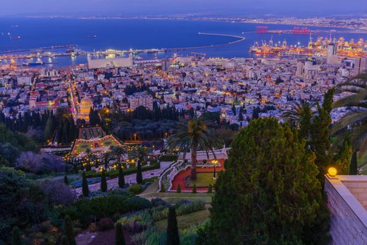 Evening view of the Bahai Shrine and gardens, with the downtown and the port, in Haifa, Northern Israel