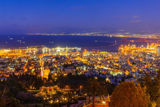 Night view of the Bahai Shrine and gardens, with the downtown and the port, in Haifa, Northern Israel