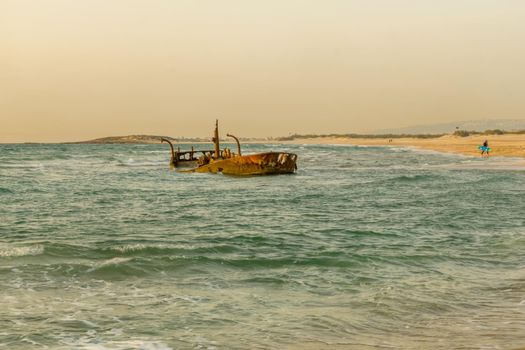 Sunset view of a rusty shipwreck in HaBonim Beach, Northern Israel