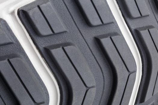 close-up full frame background of new generic contemporary sneakers outsole with protector shapes.